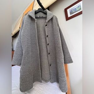Small, G.K.O mid length coat with two side pockets. Silver and black buttons.